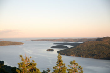 Scenic view from the top of the High Coast area of Sweden with forests, cliffs and the ocean.